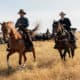 Two characters (played by Benedict Cumberbatch and Jesse Plemons) riding horses in The Power Of The Dog