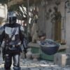 Pedro Pascal as Din Djarin and Grogu in season 3 of The Mandalorian.