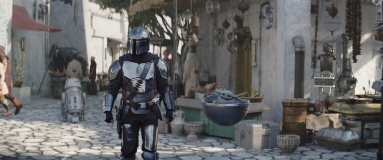 Pedro Pascal as Din Djarin and Grogu in season 3 of The Mandalorian.