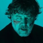 Russell Crowe in a brown curly wig for the new The Exorcism trailer
