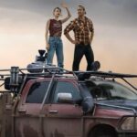 the cast of twisters stood on an old jeep