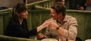materialists pedro pascal and dakota johnson in a restaurant