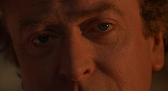 Michael Caine looking at a wolf