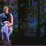 Spud clutching a soiled sheet in Trainspotting The Musical