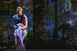 Spud clutching a soiled sheet in Trainspotting The Musical