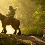 A man on a horse confronts a girl on a bicycle in the woods in a new stop-motion animated film from Laika, Wildwood