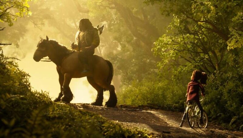 A man on a horse confronts a girl on a bicycle in the woods in a new stop-motion animated film from Laika, Wildwood